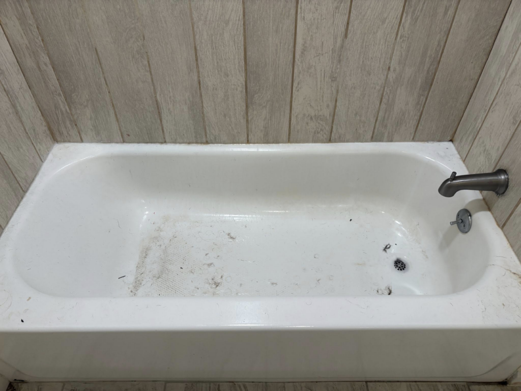 A dirty bathtub with visible grime and debris before cleaning by Tri-State Clean Queen in Elsmere, KY.