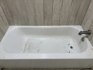 A dirty bathtub with visible grime and debris before cleaning by Tri-State Clean Queen in Elsmere, KY.