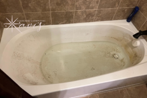 A dirty bathtub before cleaning by Xavi's Cleaning Services in Columbus, OH.