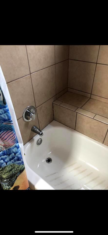 A close-up view of a dirty bathtub before professional cleaning by Klean Living in Lawson, Dallas, TX.