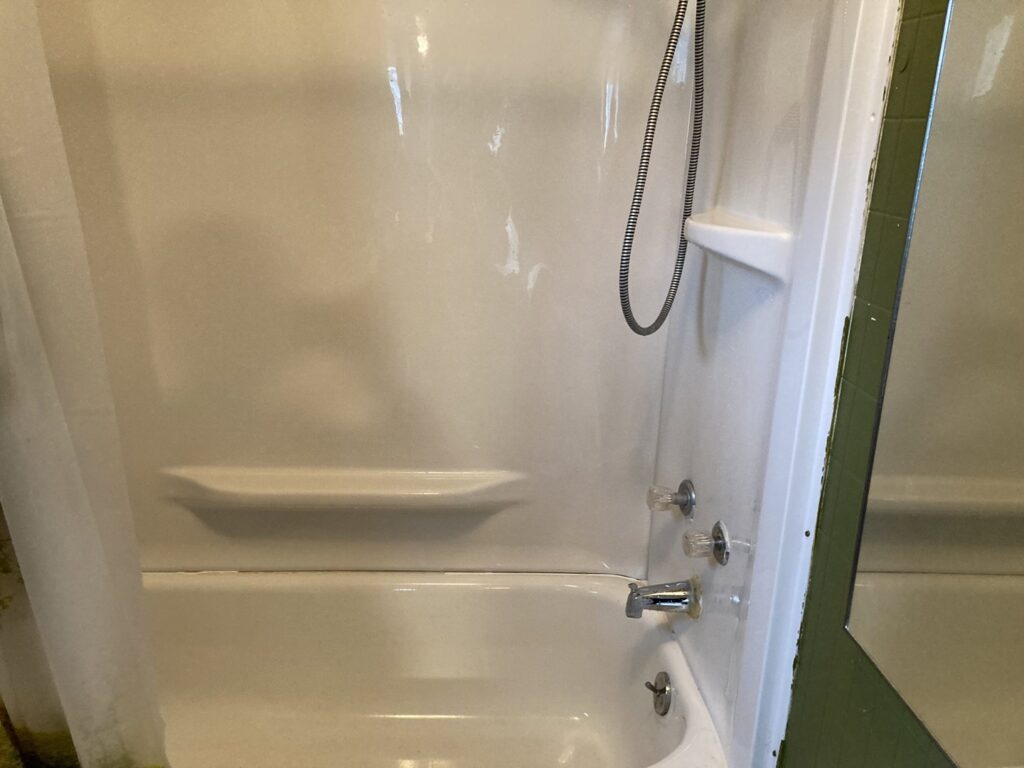 A dirty bathtub and shower needing professional cleaning by G & S Cleaning Services in Somerville, NJ.
