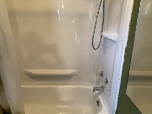 A dirty bathtub and shower needing professional cleaning by G & S Cleaning Services in Somerville, NJ.