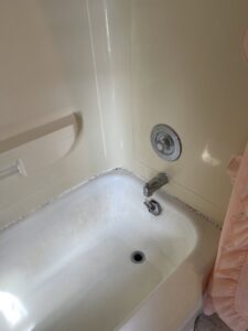 A dirty bathtub with visible mildew and grime along the edges before cleaning by Cinderellas Cleaning in Cerritos, CA
