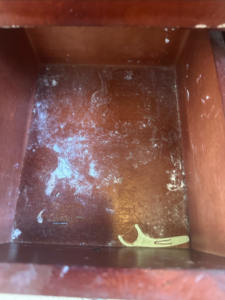 A dirty drawer filled with dust and debris, before house cleaning by Sarah's Cleaning Services in Kenner, LA.