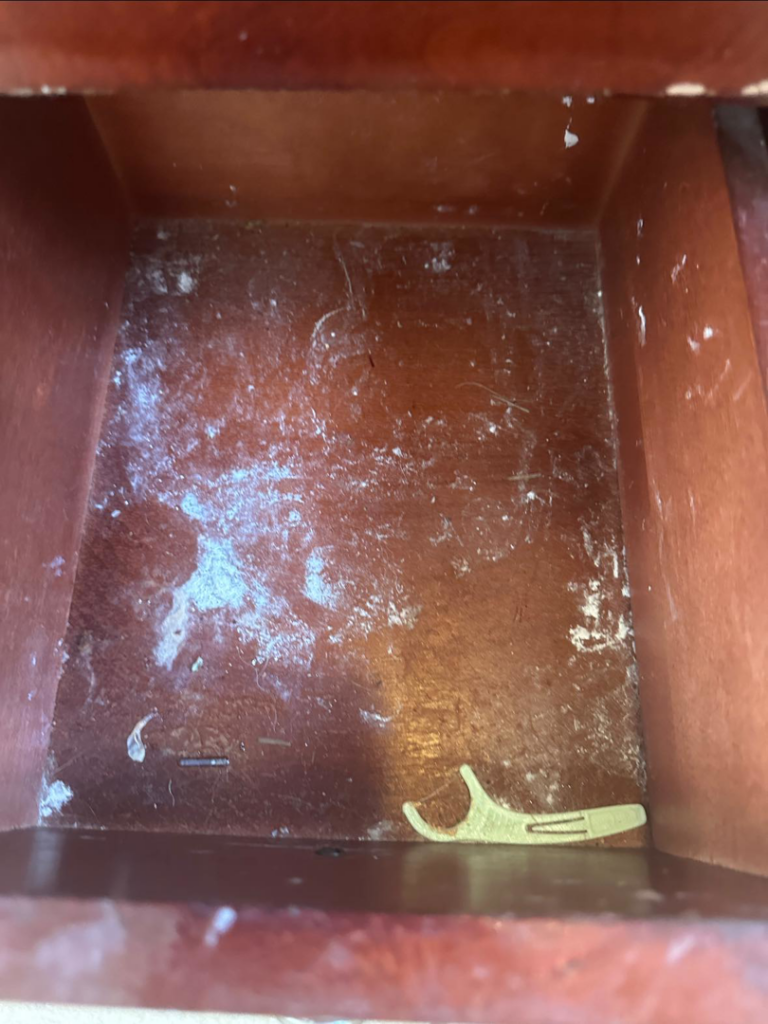 A dirty drawer filled with dust and debris, before house cleaning by Sarah's Cleaning Services in Kenner, LA.