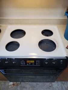 A dirty electric stovetop with grime and spills, showing a 'before cleaning' state for Quickcleanup full service cleaning in Juneau, AK.