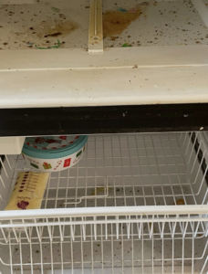 A very dirty freezer compartment with spills and debris, indicating a need for deep cleaning by Crystal Clear Cleaning Services in New Haven, CT