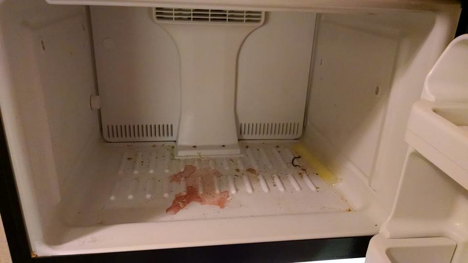 A dirty freezer interior with spills before professional cleaning by Antioch Professional Cleaning in Manchester, NH.
