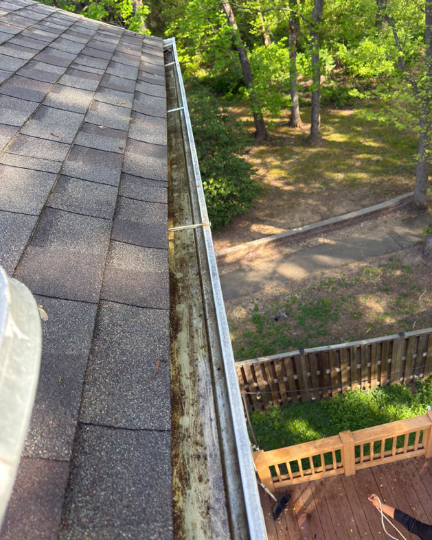 A dirty house gutter filled with leaves and debris before cleaning by Procleanersofdmv in Rockville, MD.