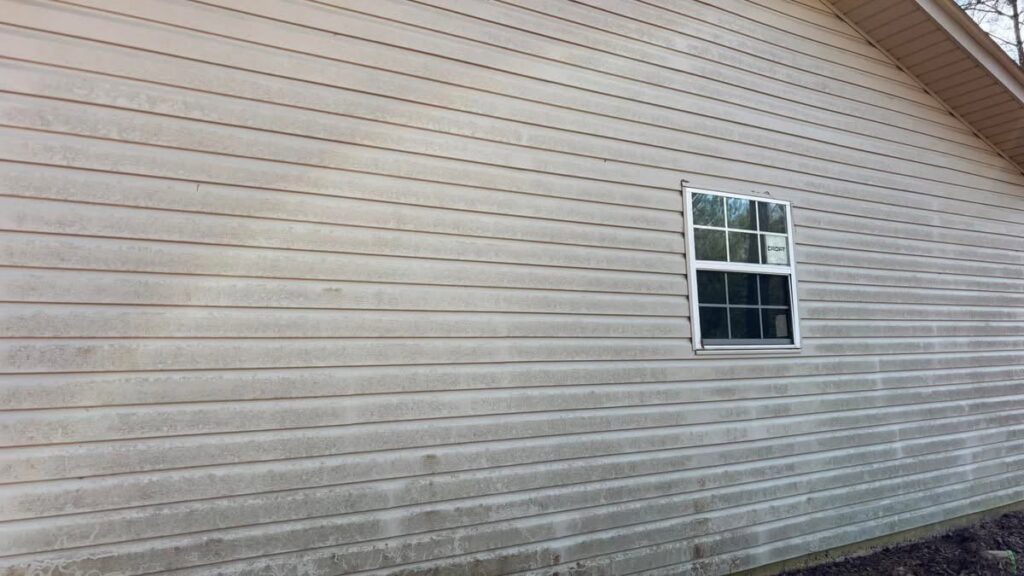 Dirty house siding covered in mold and grime before power washing by Plains Power Washing in Auburn, AL.