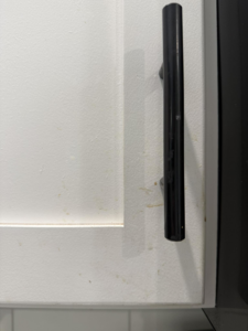 Dirty kitchen cabinet with smudges and grime before professional cleaning by We Maid It Two Cleaning Services LLC in Owensboro, KY.
