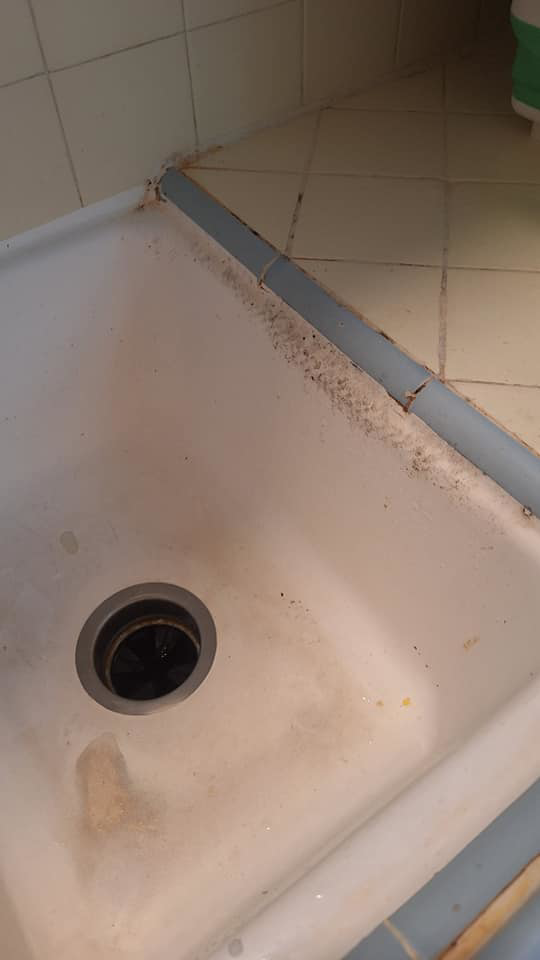 A very dirty kitchen sink with visible grime and mold before cleaning by Quality Cleaning for Less in Los Angeles, CA.