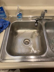 A dirty kitchen sink with visible residue, indicating a cleaning task for Final Touch & More in Fort Wayne, IN