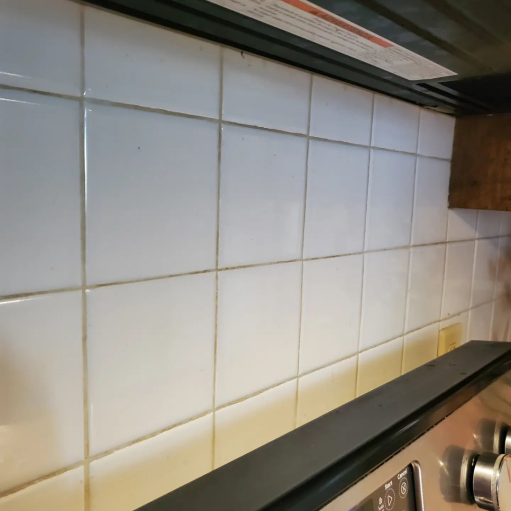 A dirty kitchen tile backsplash and grout lines, ready for cleaning by Impeccable Cleaning Service in Columbia, SC.