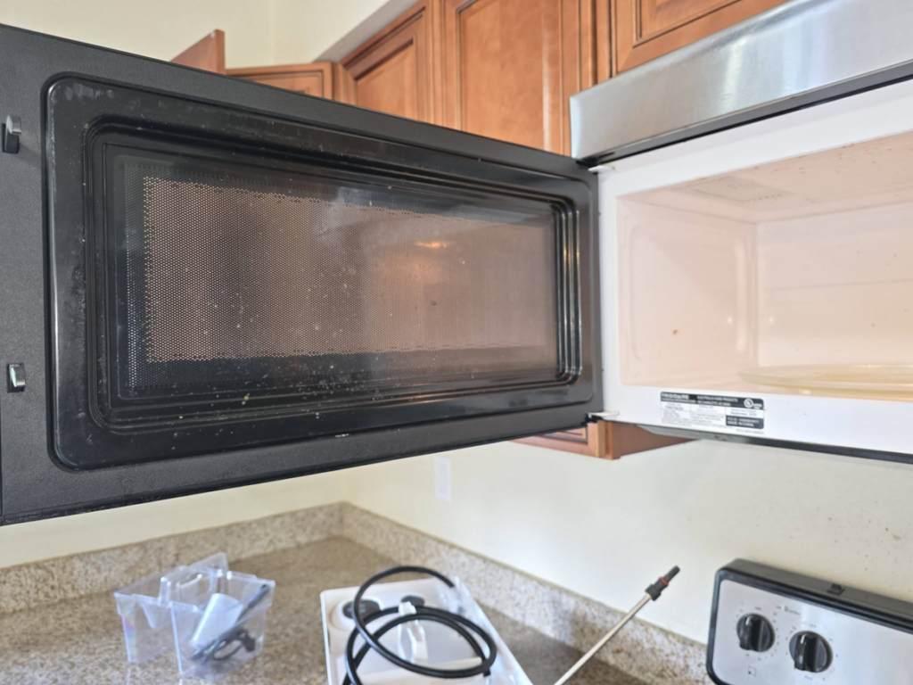 A dirty microwave exterior and interior before cleaning by Perfectly Maid in Spokane, WA.