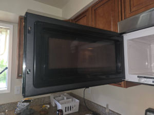 A dirty microwave interior before cleaning by Perfectly Maid in Spokane, WA.