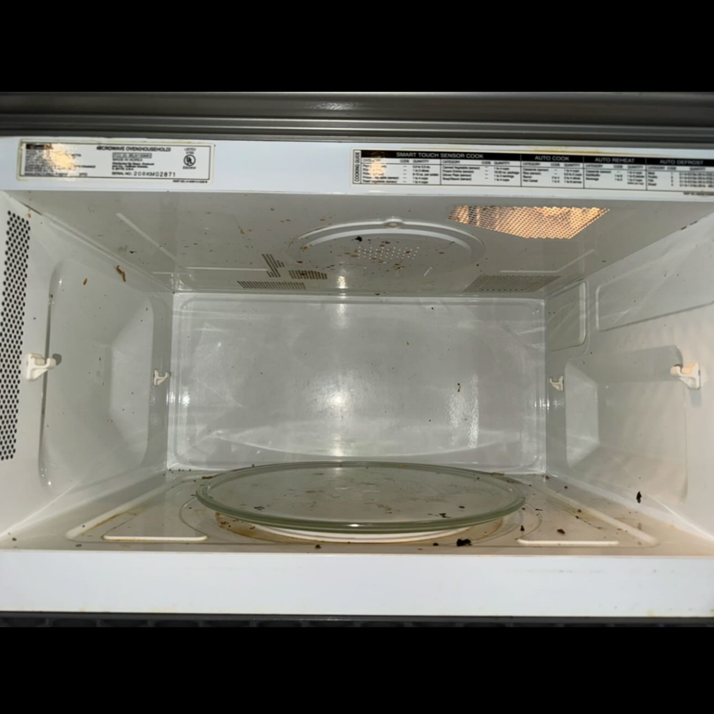 A dirty microwave interior before cleaning by Prime Cleaners LLC in Kansas City, MO.