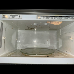 A dirty microwave interior before cleaning by Prime Cleaners LLC in Kansas City, MO.