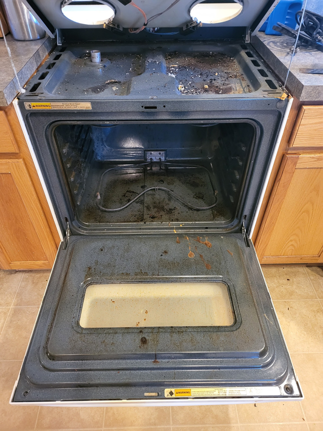 A very dirty oven and stovetop before professional cleaning by Blossom Cleaning & Organizing LLC in South Bend, IN.