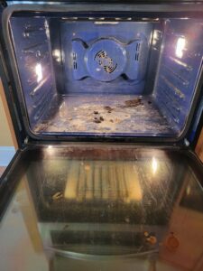 A dirty oven interior with baked-on grime, illustrating a challenging cleaning task for AG Simply Clean in Concord, NC.