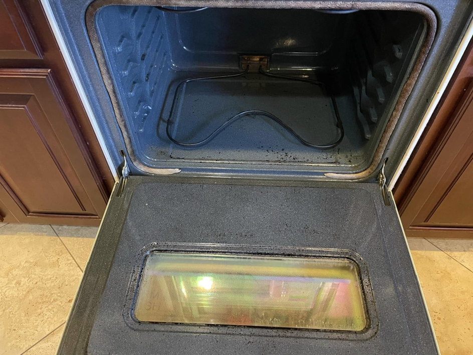 The dirty interior of an oven, showing the need for a deep cleaning service from Maid It Dirty Cleaning Company in Phoenix, AZ.