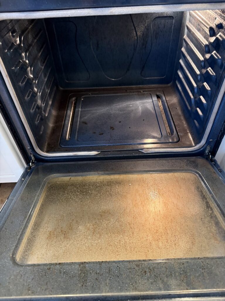 A dirty oven interior with baked-on grime, illustrating a 'before' cleaning challenge for Messy To Clean in Aurora, IL.