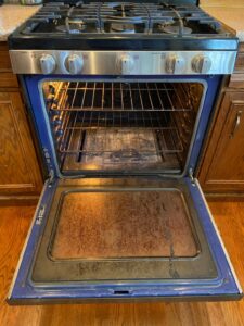 A dirty oven interior before professional cleaning by No Stress Cleaning Services in Virginia Beach, VA