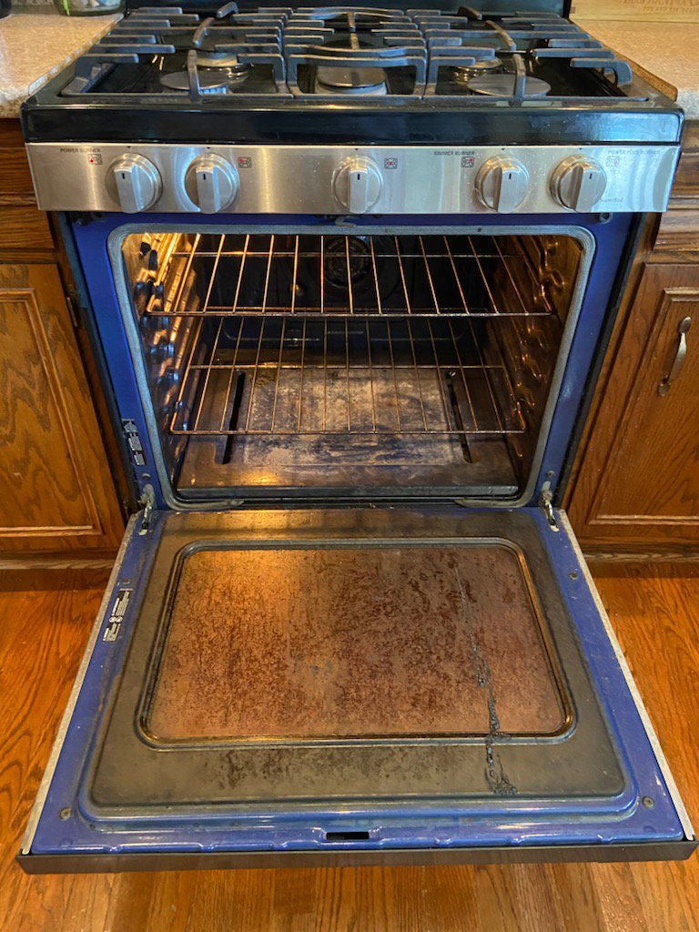 A dirty oven interior before professional cleaning by No Stress Cleaning Services in Virginia Beach, VA