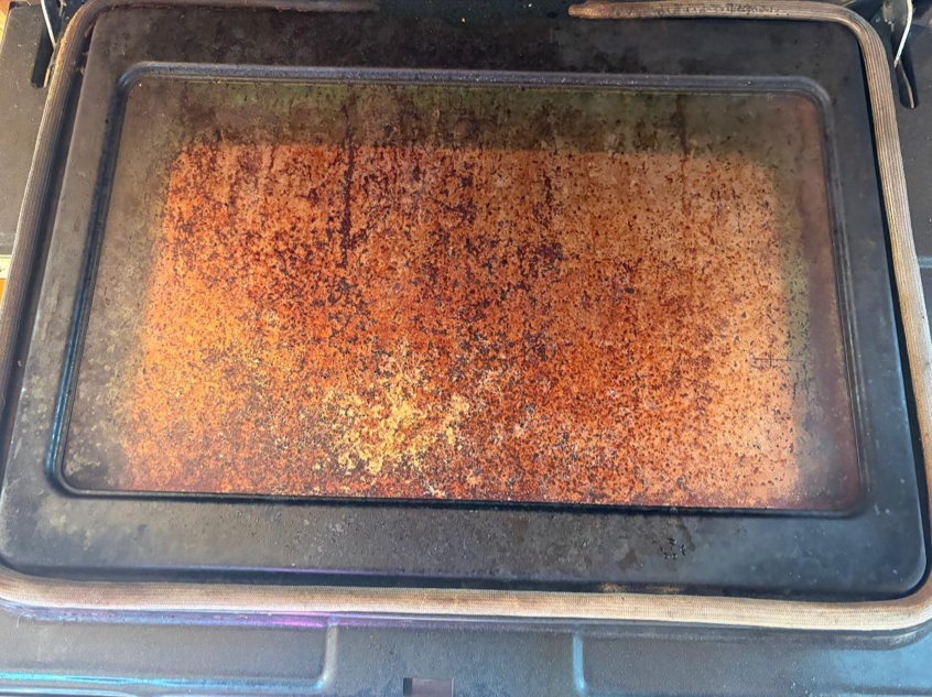 A very dirty oven interior with baked-on grime, showing a before-cleaning state by The Scrub Club in Concord, NH.