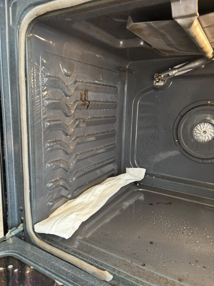 The dirty interior of an oven before professional cleaning by Tidy Townhouses in Manchester, NH.