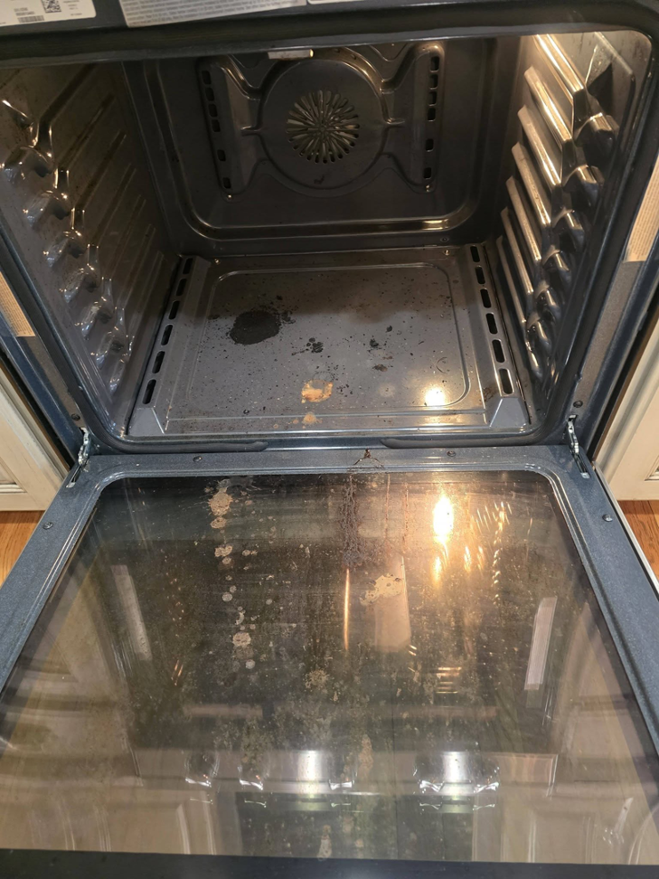 A dirty oven interior before professional cleaning by Wonderful Laura Cleaning in Aurora, IL.