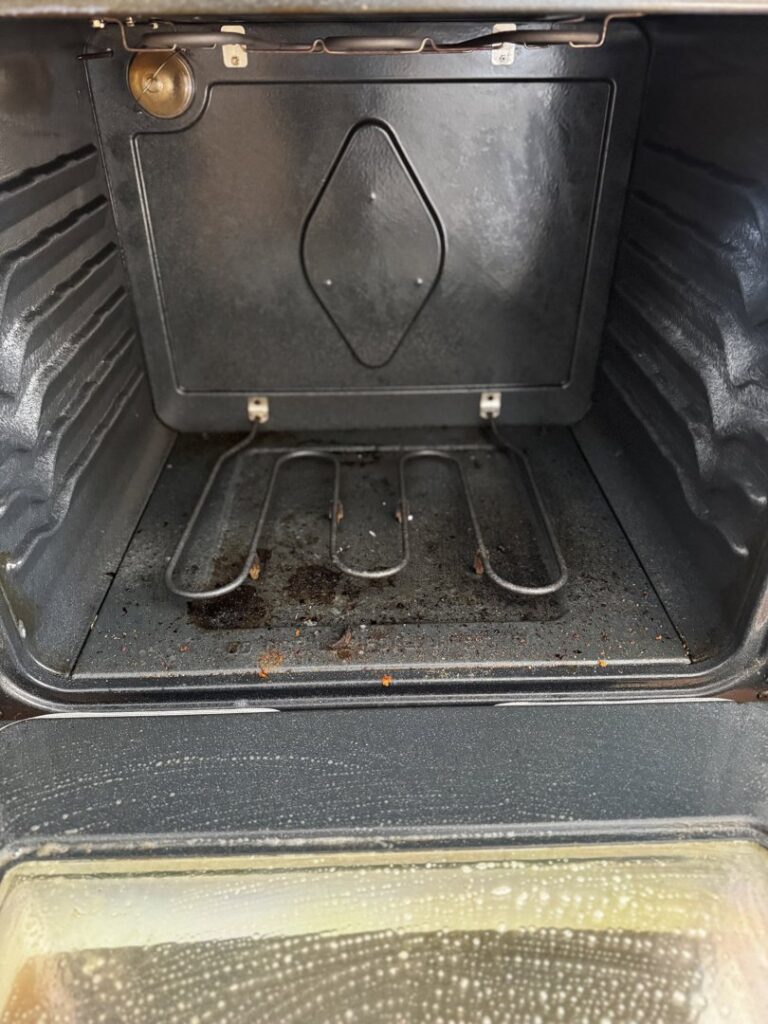 A dirty oven interior being cleaned by New Clean Service in Wilmington, NC, showing the effectiveness of their house cleaning.