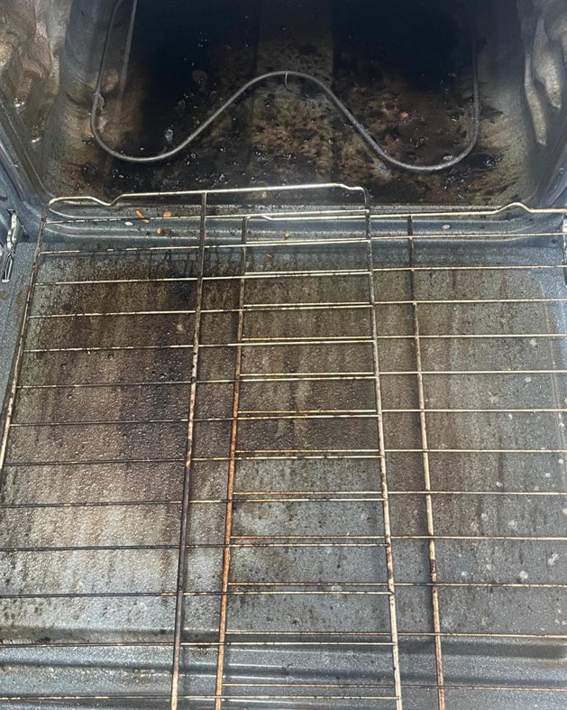 The dirty interior of an oven with racks, a common deep cleaning task for Home Clean Home By Maria LLC in Aberdeen, SD.