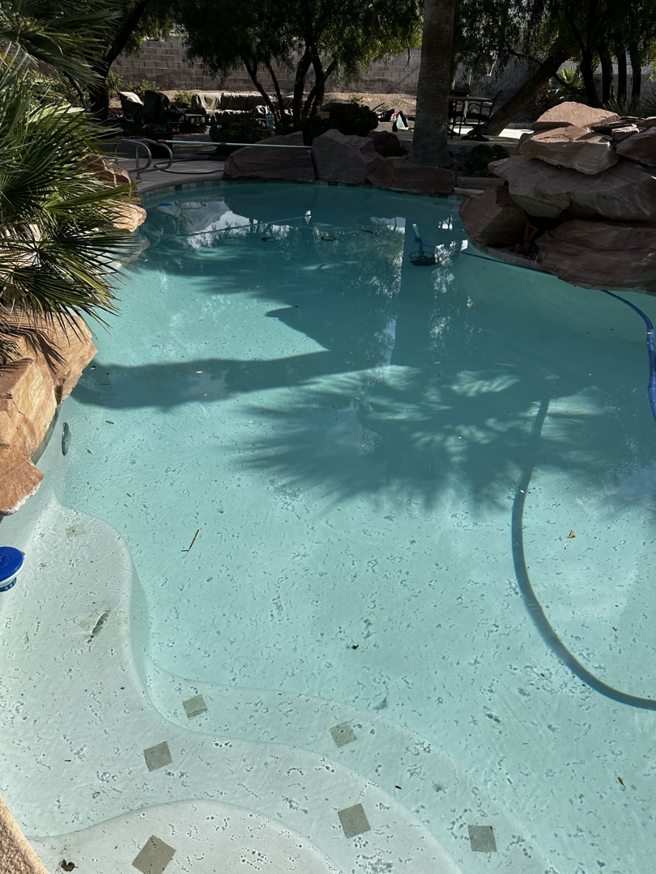 A dirty residential pool filled with leaves and debris, ready for cleaning by AquaMac Pool Cleaning Service LLC in Reno, NV.