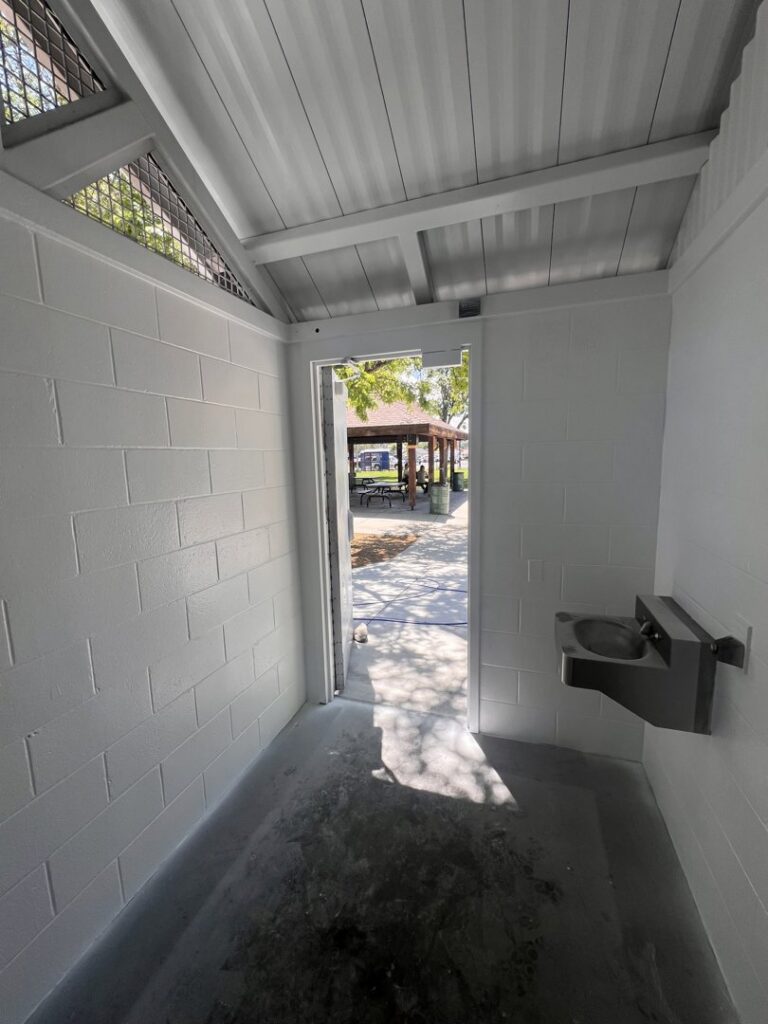 A dirty public restroom stall floor before cleaning by EB Restorations & Cleaning Services in Sparks, NV