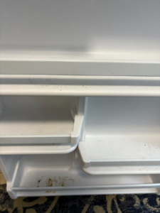 Dirty shelves inside a refrigerator door, ready for deep cleaning by Sprinkled Clean in Bangor, ME.