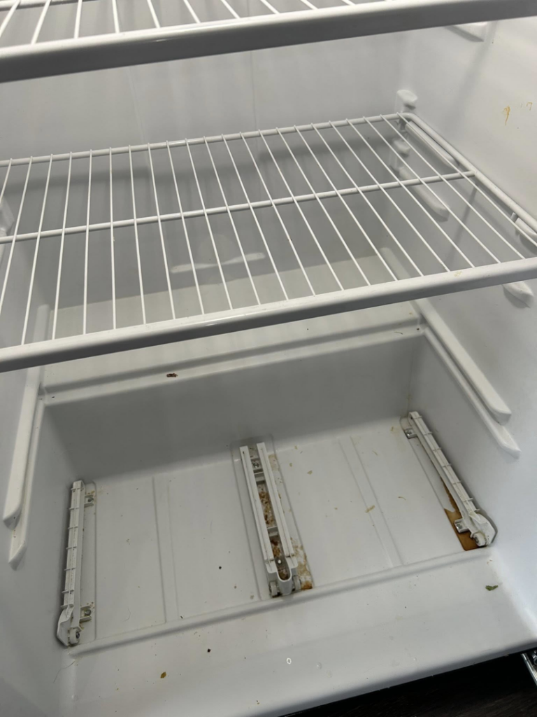 The dirty interior of a refrigerator before professional cleaning by E & S Cleaning Services L.L.C in Nampa, ID.