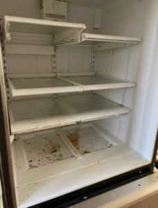 A very dirty refrigerator interior with shelves removed, showing grime and rust, ready for deep cleaning by Crystal Clear Cleaning Services in New Haven, CT