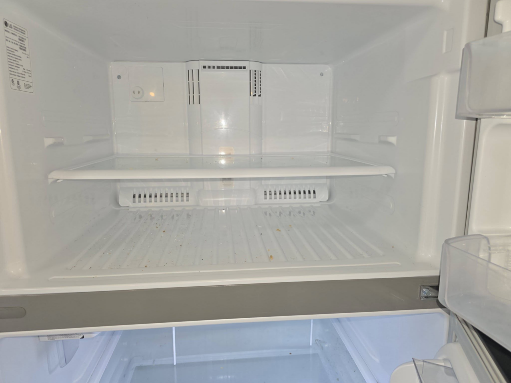 A dirty refrigerator interior before professional cleaning by Perfectly Maid in Spokane, WA.