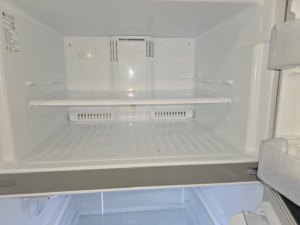 A dirty refrigerator interior before professional cleaning by Perfectly Maid in Spokane, WA.