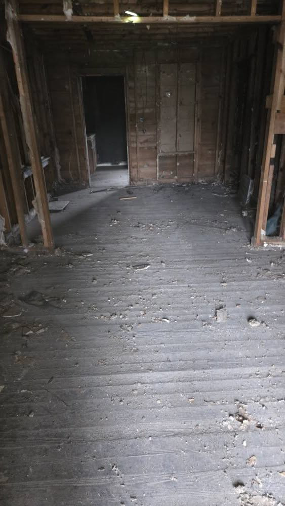 A very dirty room with debris on the floor, ready for deep cleaning by Klean Cut Cleaning in Flint, MI.