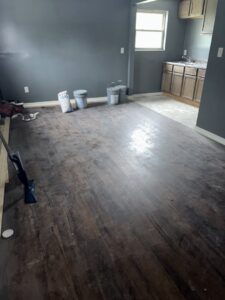 A dirty room with cleaning equipment and buckets, ready for cleaning by Perfections Quality Cleaning Service in Dayton, OH.