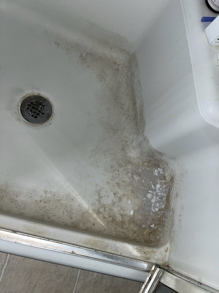A very dirty shower floor before professional cleaning by No Stress Cleaning Services in Virginia Beach, VA