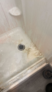 A very dirty shower stall before cleaning by Best Bay Area Cleaners in Oakland, CA.