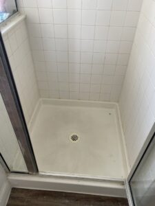 A dirty shower stall with grime on the tiles and floor, showing a "before" cleaning state by Picky Performance Cleaning in North Las Vegas, NV