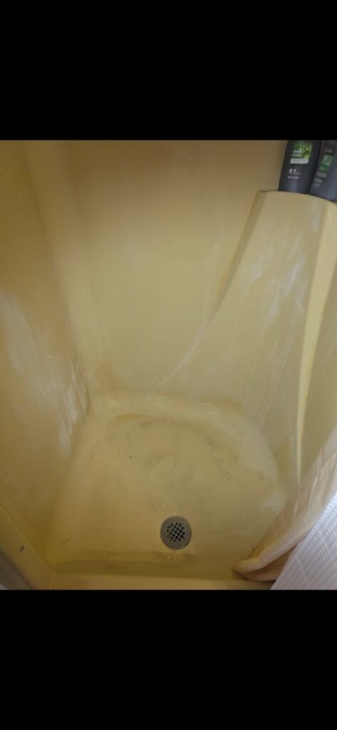 A dirty shower stall showing grime and soap scum before cleaning by MJ Commercial & Residential Cleaning, LLC in Cedar Rapids, IA.
