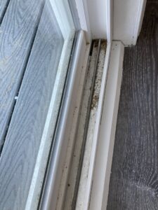 A dirty sliding door track with accumulated grime, ready for cleaning by G & S Cleaning Services in Somerville, NJ.