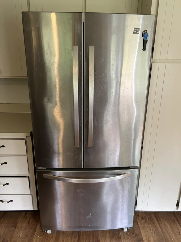 A smudged stainless steel refrigerator needing cleaning by V's Residential Cleaning Services in Tacoma, WA.