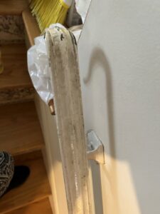 A dirty stair handrail showing accumulated grime, indicating a need for cleaning by Wilkie Wonders Cleaning in Akron, OH.