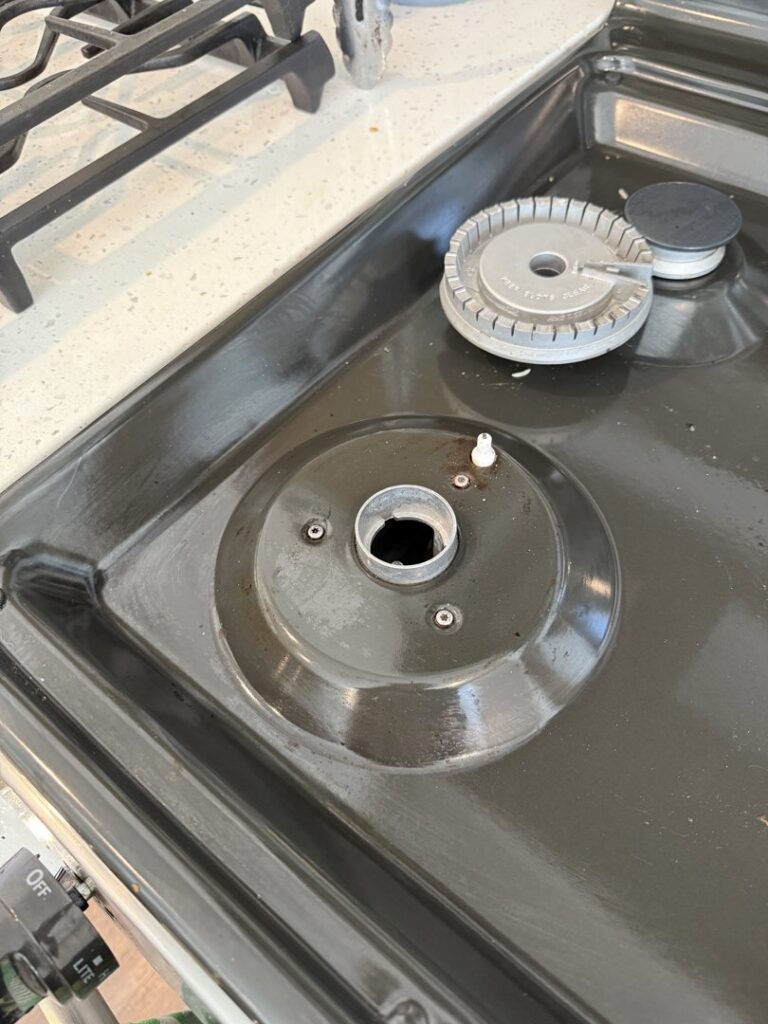 A dirty stove burner area with grease and grime, illustrating a 'before' cleaning challenge for Messy To Clean in Aurora, IL.